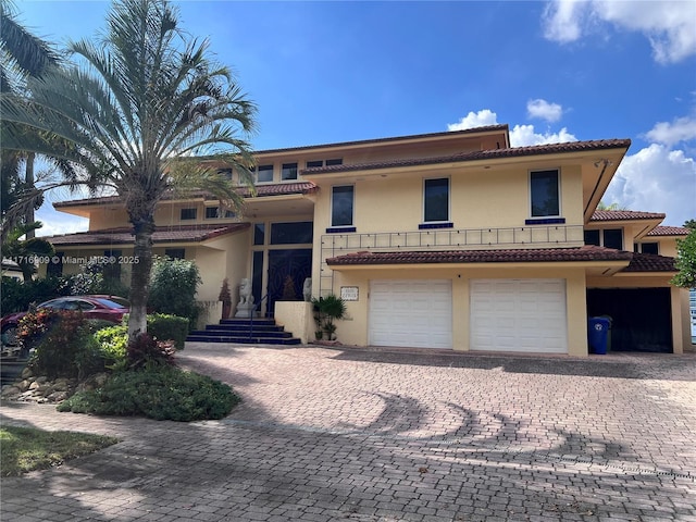 mediterranean / spanish home featuring a garage