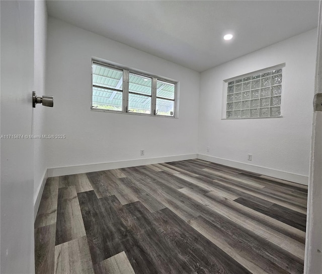 spare room with dark hardwood / wood-style flooring