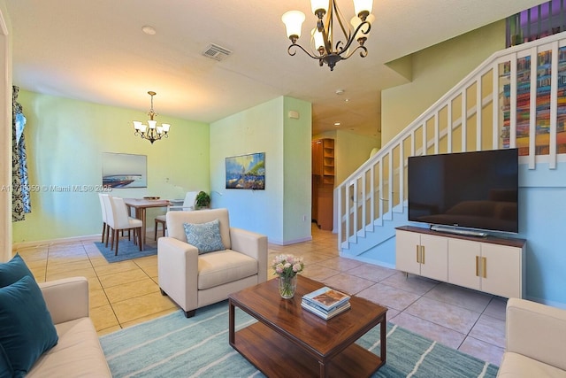 living room featuring a notable chandelier and light tile patterned floors