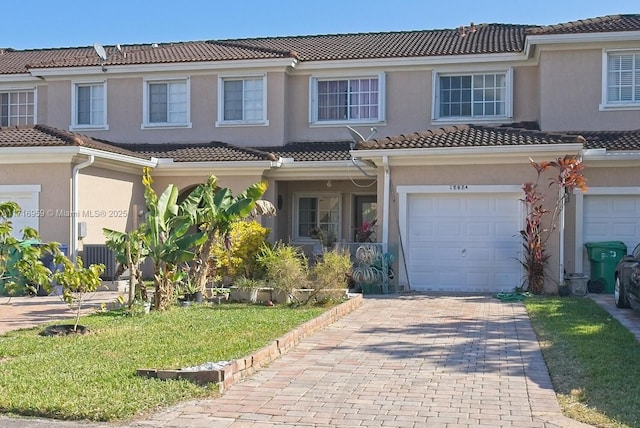 mediterranean / spanish home with a front yard and a garage