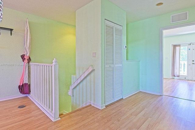 corridor with light hardwood / wood-style floors