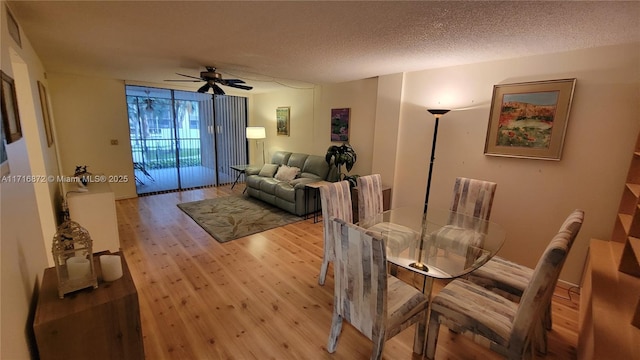 dining space featuring ceiling fan, a textured ceiling, and light wood-type flooring