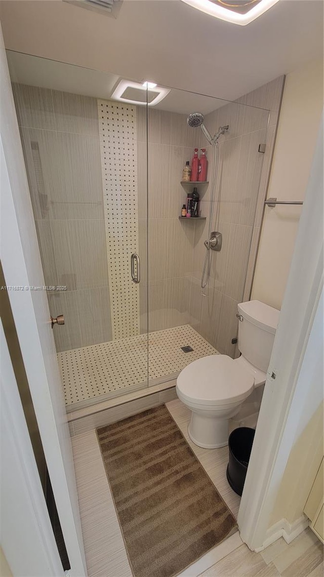 bathroom with toilet and walk in shower