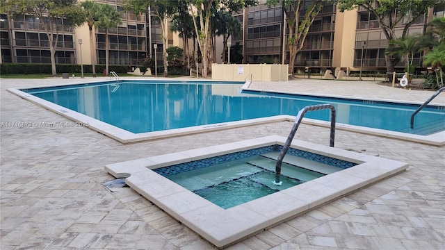 view of pool featuring a hot tub