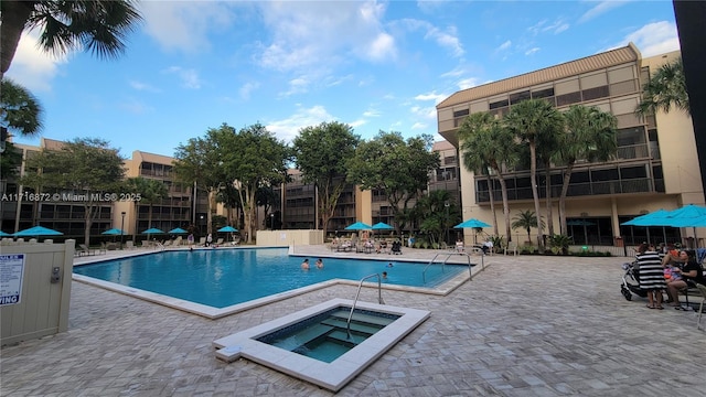 view of pool featuring a patio area and a community hot tub