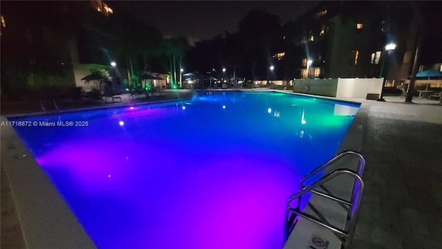 view of pool at night