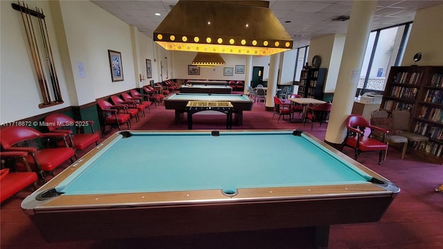 playroom with a paneled ceiling, a wall of windows, carpet floors, and pool table