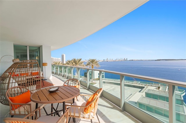 balcony with a beach view and a water view