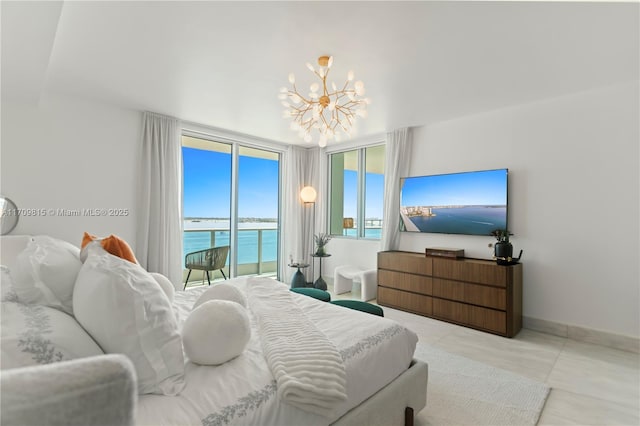 bedroom featuring access to exterior and a chandelier