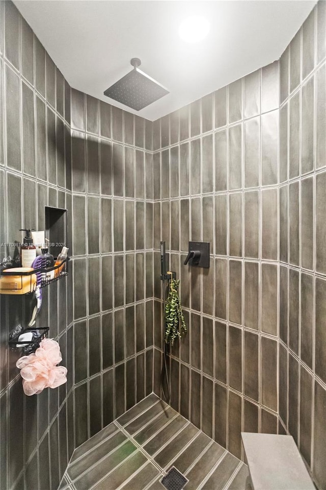 bathroom with tiled shower