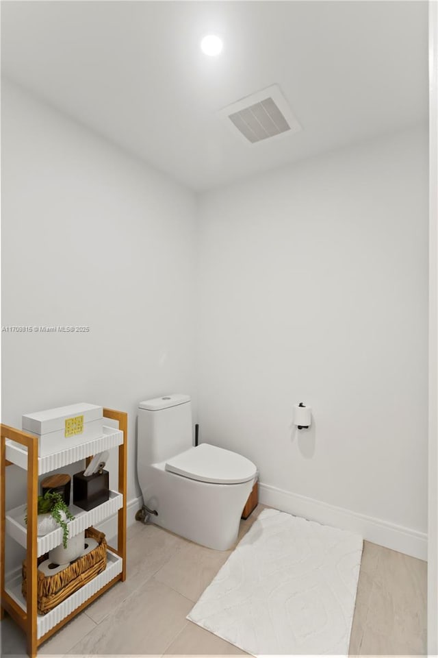 bathroom featuring tile patterned floors and toilet