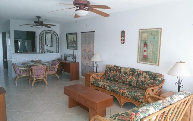 living room featuring ceiling fan and light tile patterned flooring