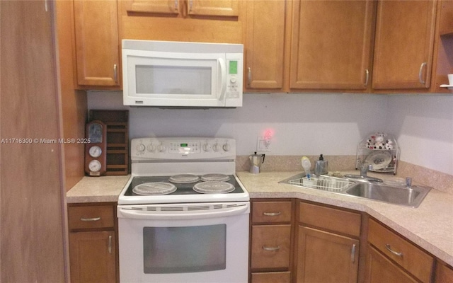 kitchen with sink and white appliances