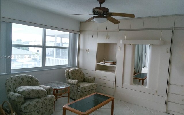 sitting room with ceiling fan and light tile patterned floors