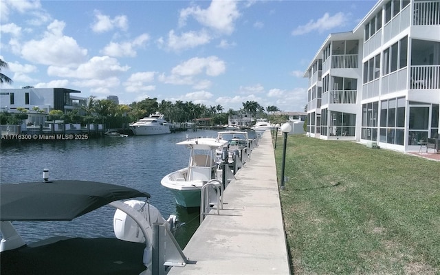 dock area with a water view and a lawn