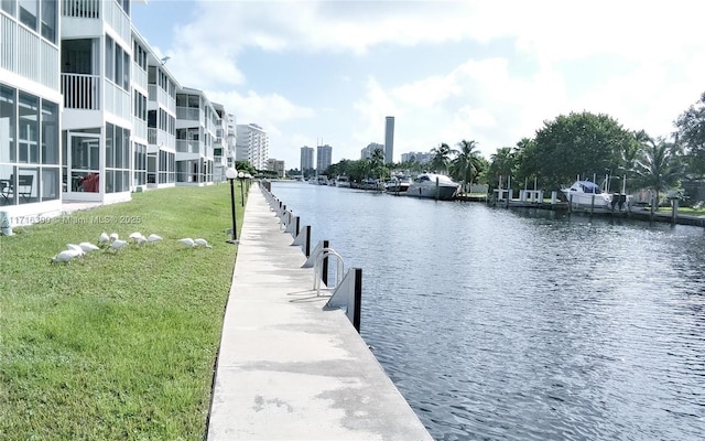 dock area featuring a yard and a water view