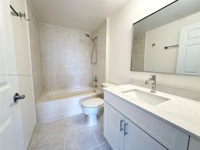 full bathroom featuring vanity, tiled shower / bath combo, and toilet