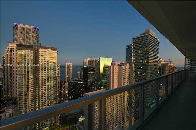 balcony at dusk with a view of city