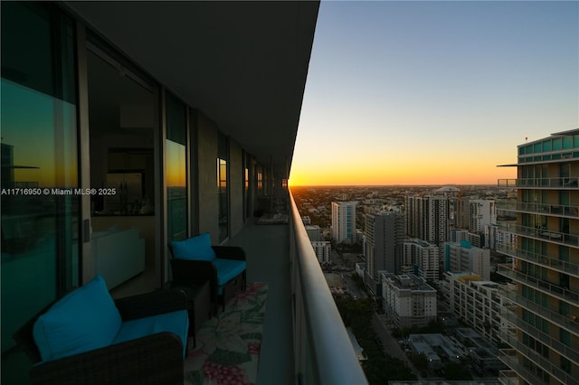 balcony at dusk with a view of city