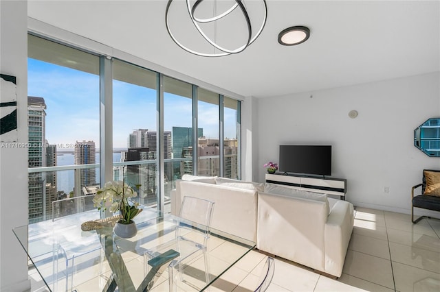 tiled living area featuring a wall of windows and baseboards