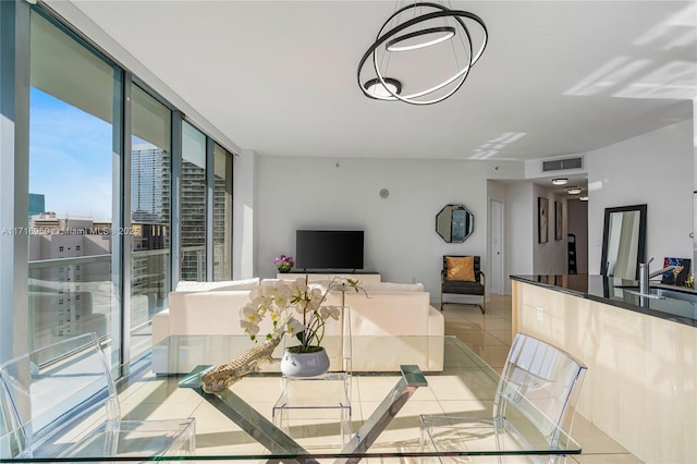 dining room featuring light tile patterned floors, visible vents, and expansive windows