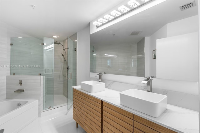 bathroom with a shower stall, visible vents, and a sink