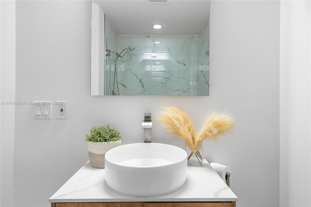 full bathroom with vanity, visible vents, and a marble finish shower