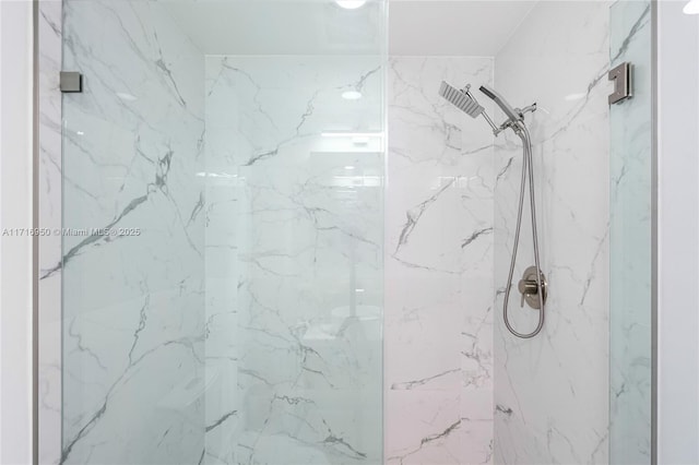 bathroom featuring a marble finish shower