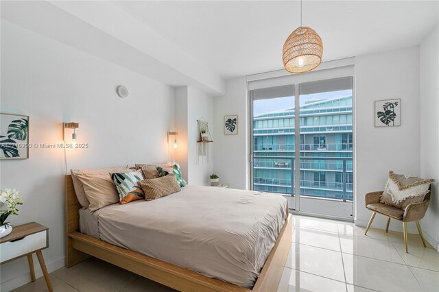 bedroom featuring light tile patterned floors and baseboards