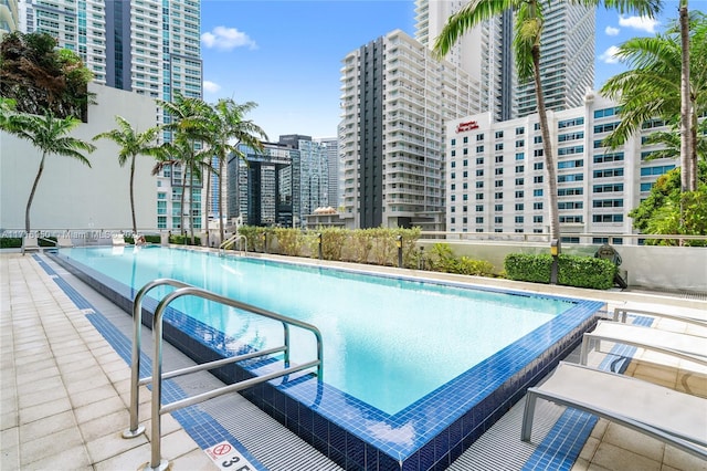 view of pool featuring a view of city