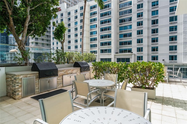 view of patio / terrace featuring outdoor dining space, area for grilling, and grilling area