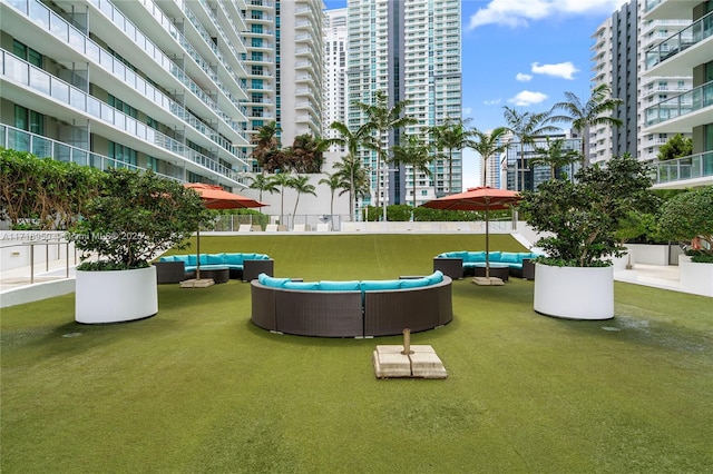 view of home's community with a city view and an outdoor living space