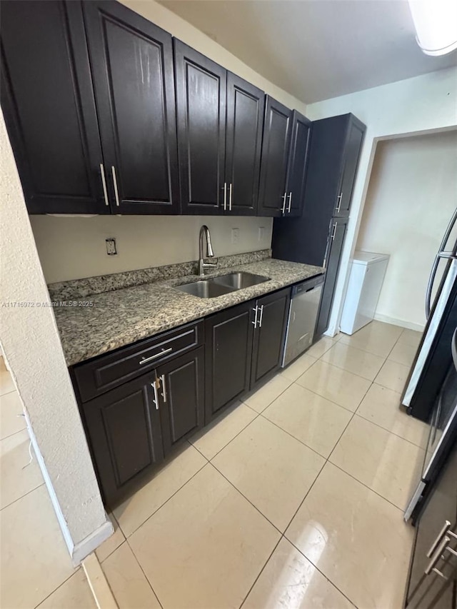 kitchen featuring dishwasher, light tile patterned flooring, stone countertops, and sink