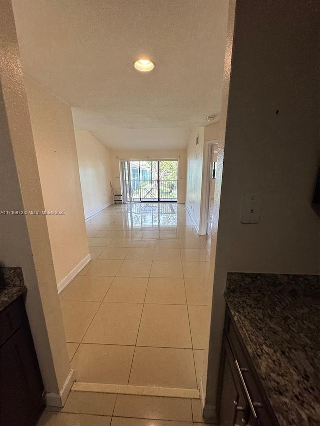 corridor featuring light tile patterned floors