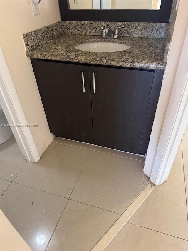 bathroom with tile patterned flooring and vanity