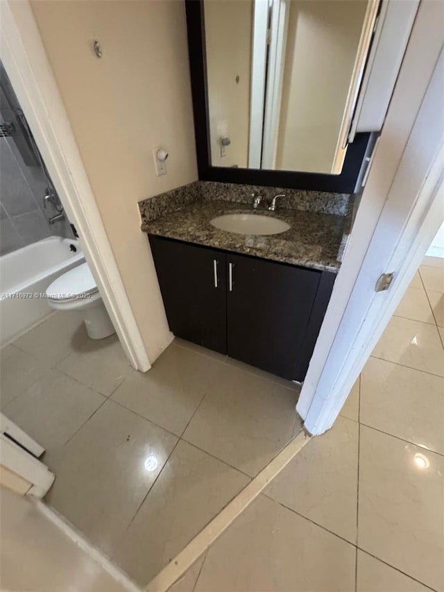 bathroom with tile patterned floors, vanity, and toilet