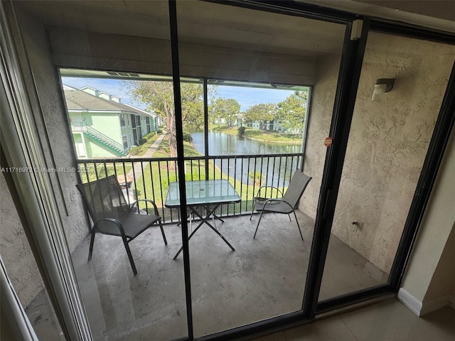 unfurnished sunroom featuring a water view