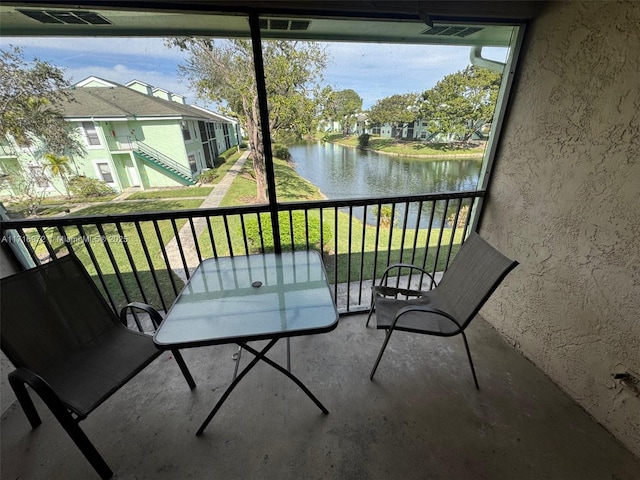 balcony featuring a water view