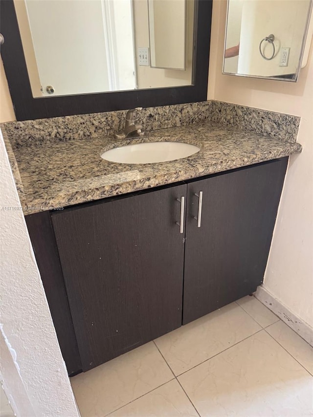 bathroom with tile patterned flooring and vanity