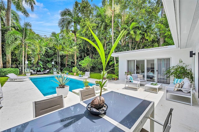 view of swimming pool featuring outdoor lounge area and a patio