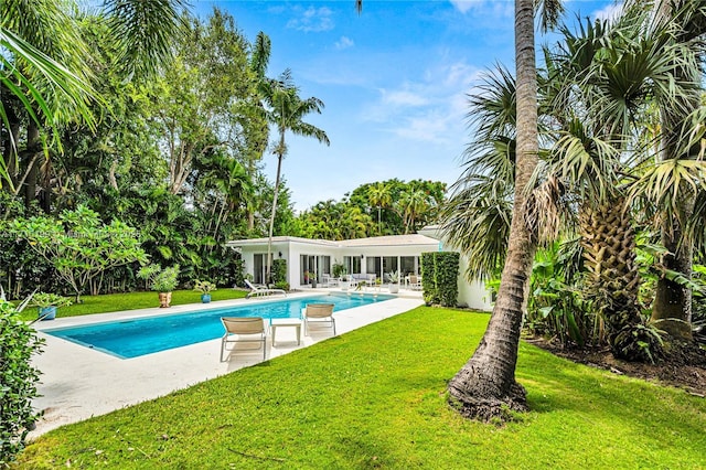 view of pool with a lawn and a patio area