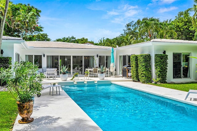 view of pool with a patio and grilling area