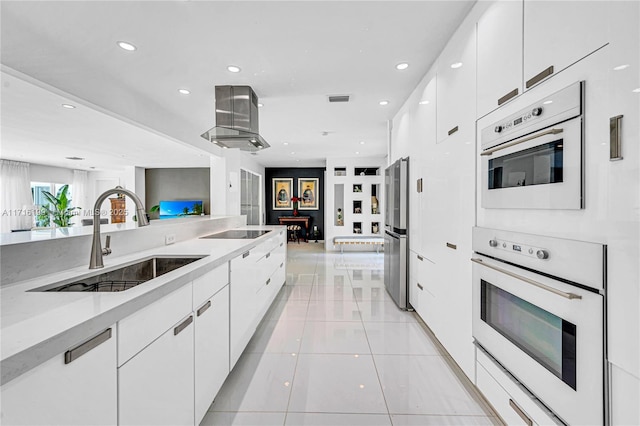 kitchen featuring black electric stovetop, sink, light tile patterned floors, light stone counters, and white cabinetry