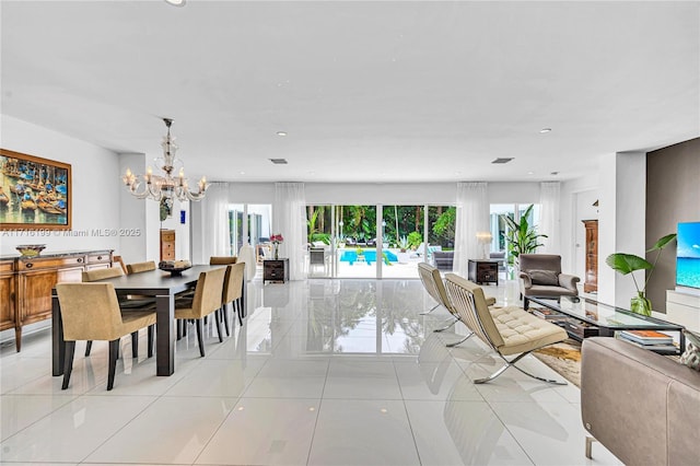 dining space with light tile patterned floors and an inviting chandelier