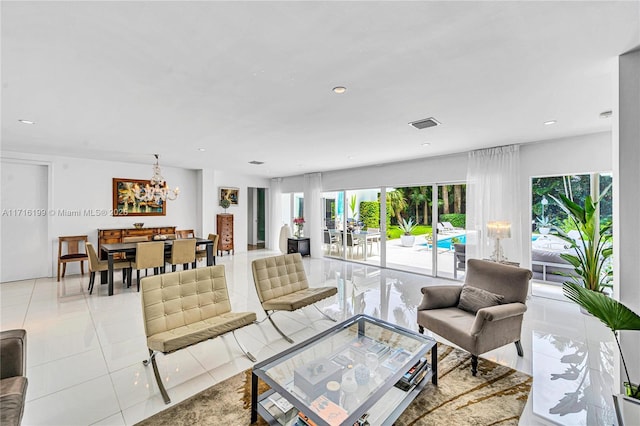 tiled living room featuring an inviting chandelier