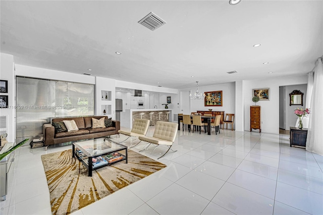 living room with light tile patterned floors and a chandelier