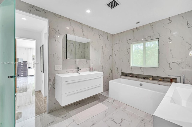 bathroom featuring vanity and a bathing tub