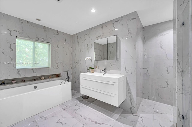 bathroom featuring a tub to relax in and vanity