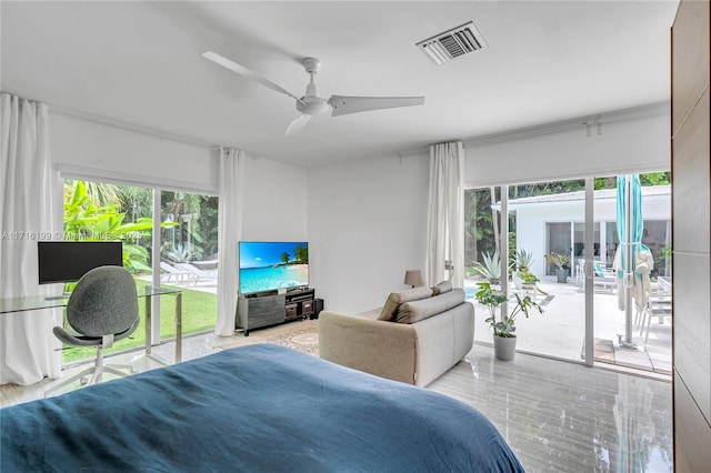 bedroom with access to outside, multiple windows, and ceiling fan