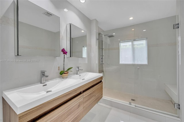 bathroom with vanity, tile patterned floors, and a shower with door